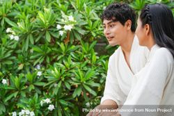 Asian couple in hotel bathrobe standing together at balcony 5aDkv0
