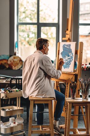 Shot of male painter at work in studio, vertical