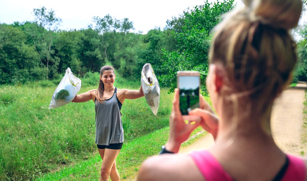 Female taking picture of a friend after plogging