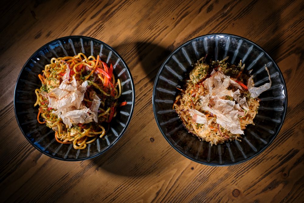 Delicious dishes in bowls served on wooden table