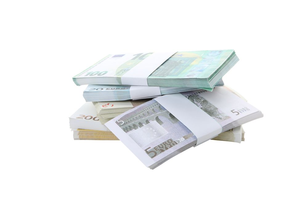 Stacks of American cash money, isolated on light background