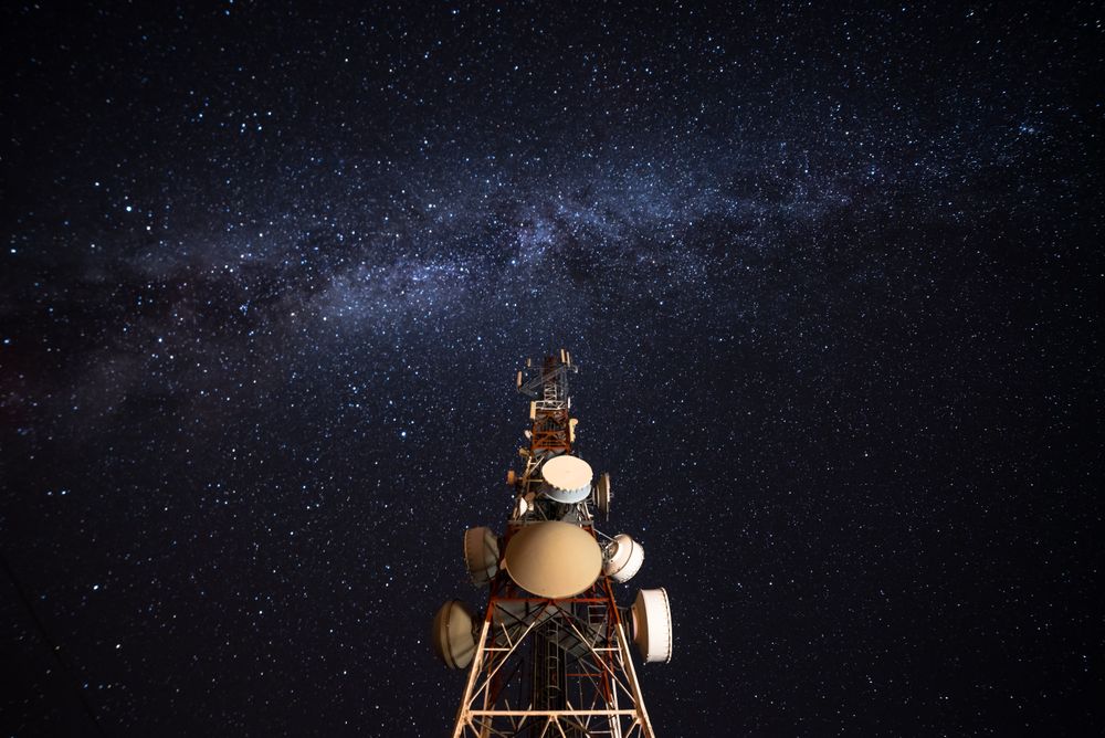 Amazing view of transmission towers against Milky Way in night sky