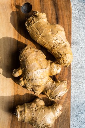 Ginger roots on wooden board