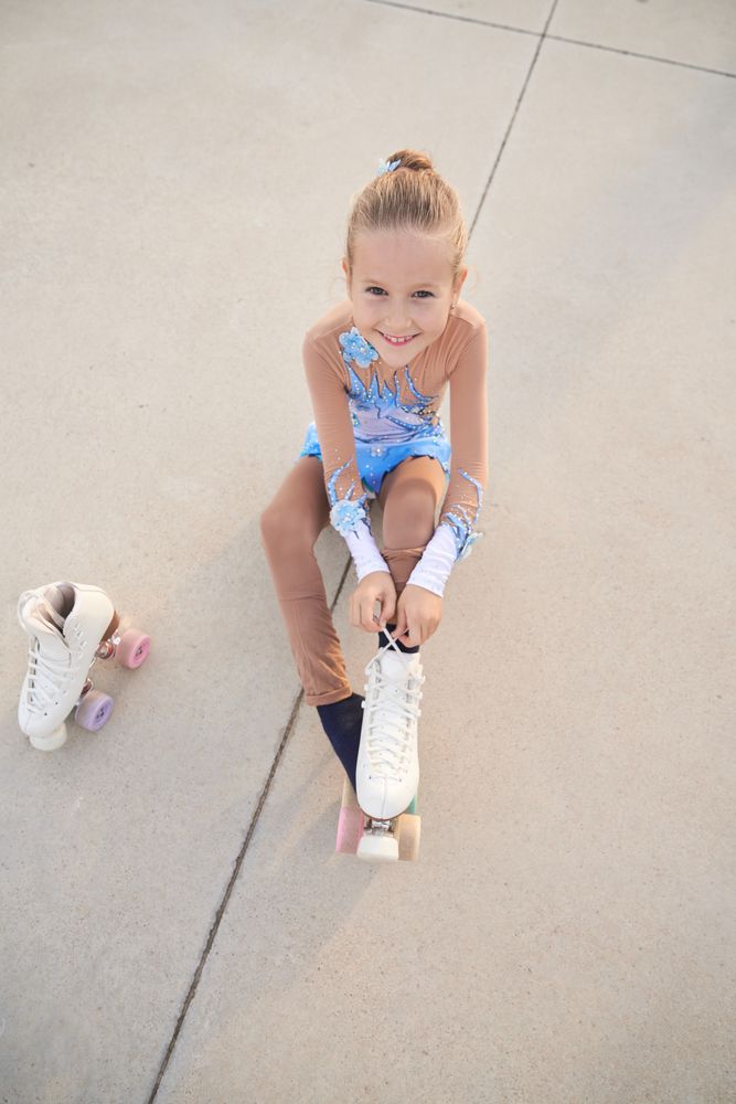 Happy girl putting on roller skate
