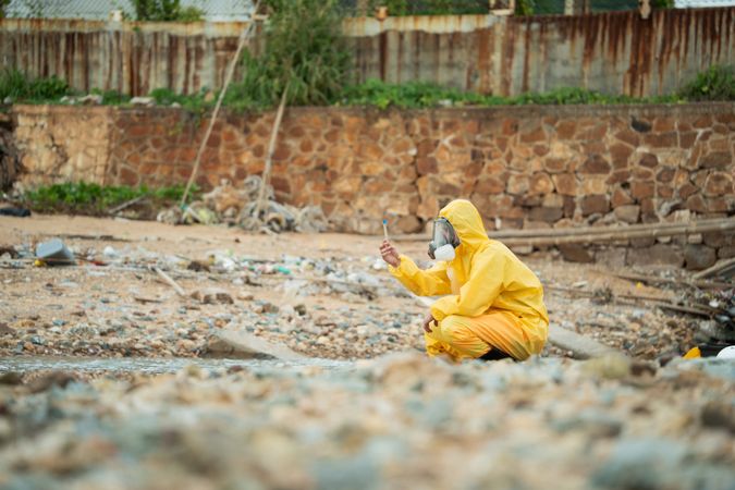 Environment scientist analysing waste water test results and collecting sample for research