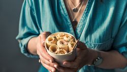 Hand holding rolled ice cream in cone cup