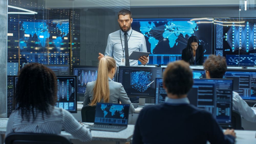 Chief Project Engineer Holds Briefing for a Team of Scientists that are Building Machine Learning System.