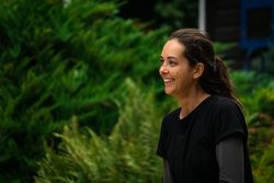 Cheerful woman resting in garden during training