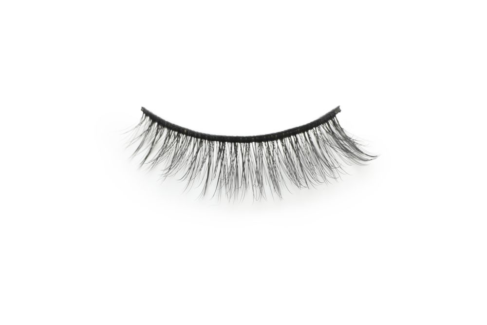 Concept of cosmetology tools, false eyelashes, isolated on light background