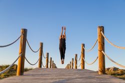Woman posing in air on footbridge