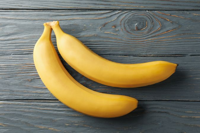 Bananas on gray wooden background. Fresh fruit