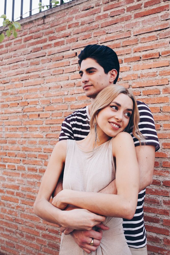 Happy couple having fun and embracing in the street