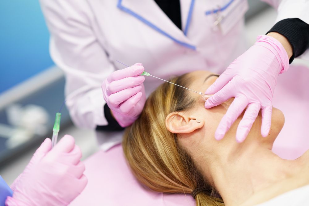 Woman having filler inserted into side of face
