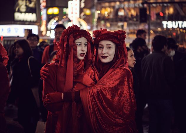 Japan - Tokyo, Shibuya Japan - November 29th, 2019: Women dressed in red with arms around each other