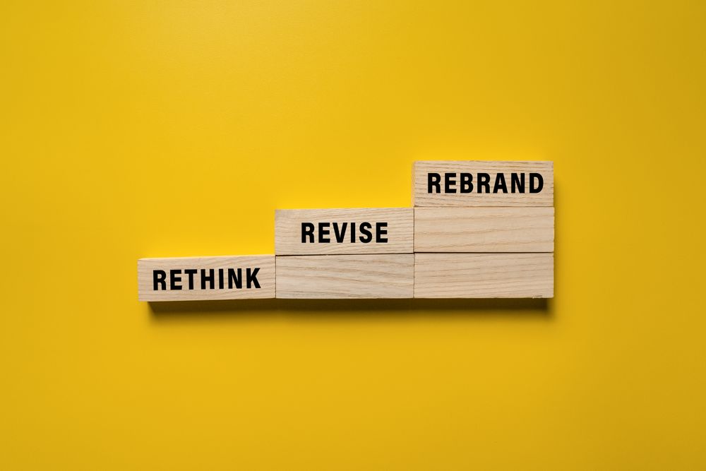 rethink revise and rebrand words on wooden blocks isolated on yellow background