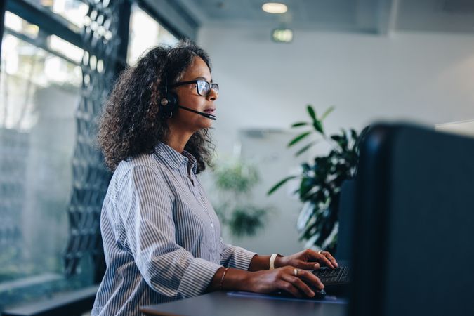 Professional woman using headset to communicate with clients