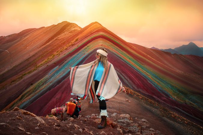 Woman standing in front of Vinicunca in Peru