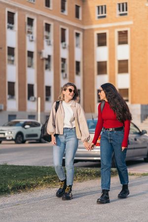student couple in college holding hands