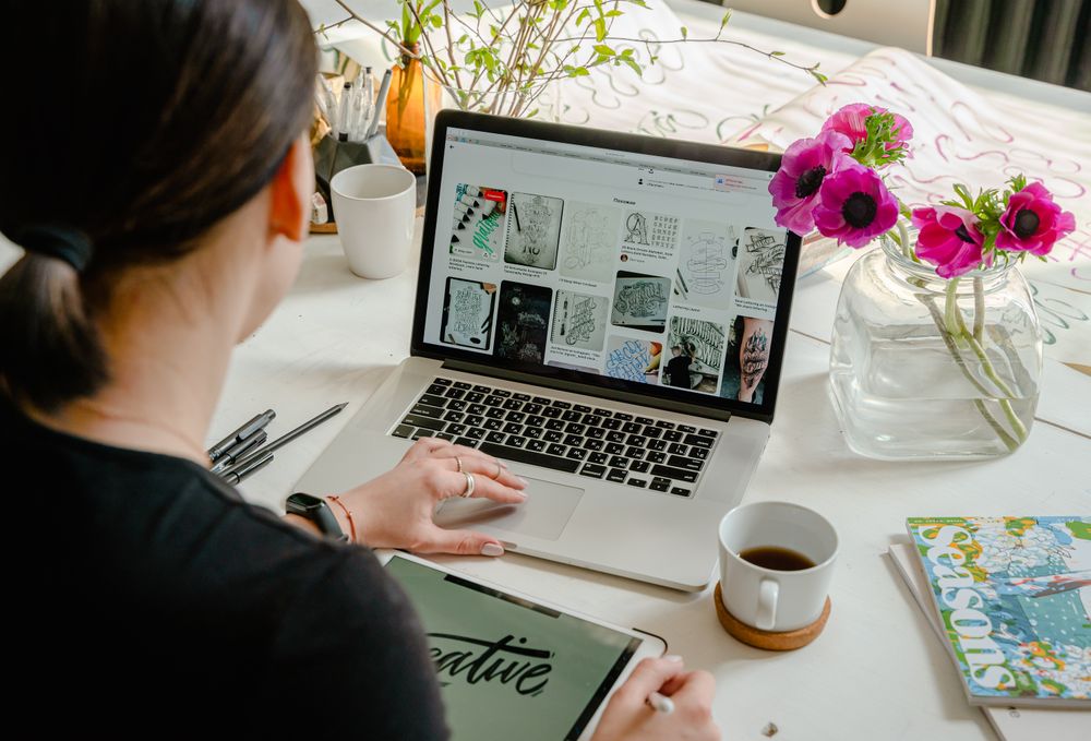 Back view of woman in dark shirt using computer