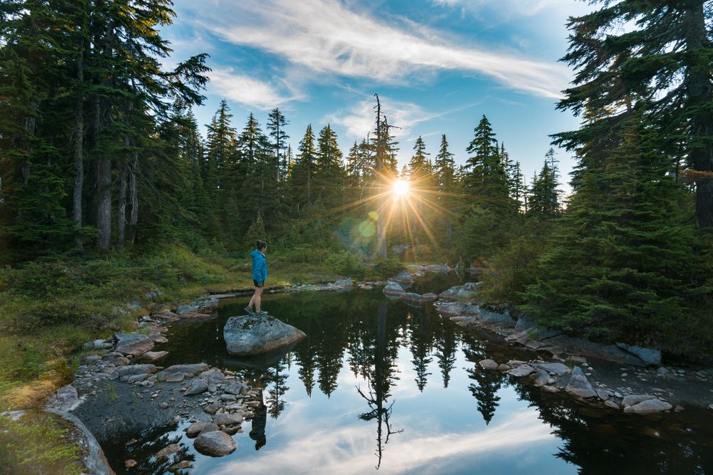 Woman standing on rock on river