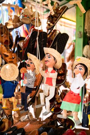 Puppets hanging at market stand for sale, vertical