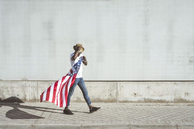 Happy black man with flying American flag