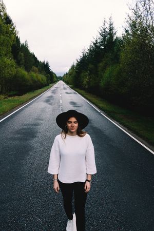 Stylish woman on remote empty road