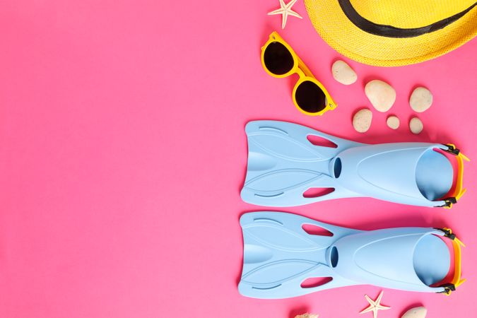 Sea vacation accessories on yellow background, top view