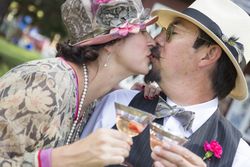 Loving Couple Dressed in 1920’s Era Fashion Sipping Champagne
