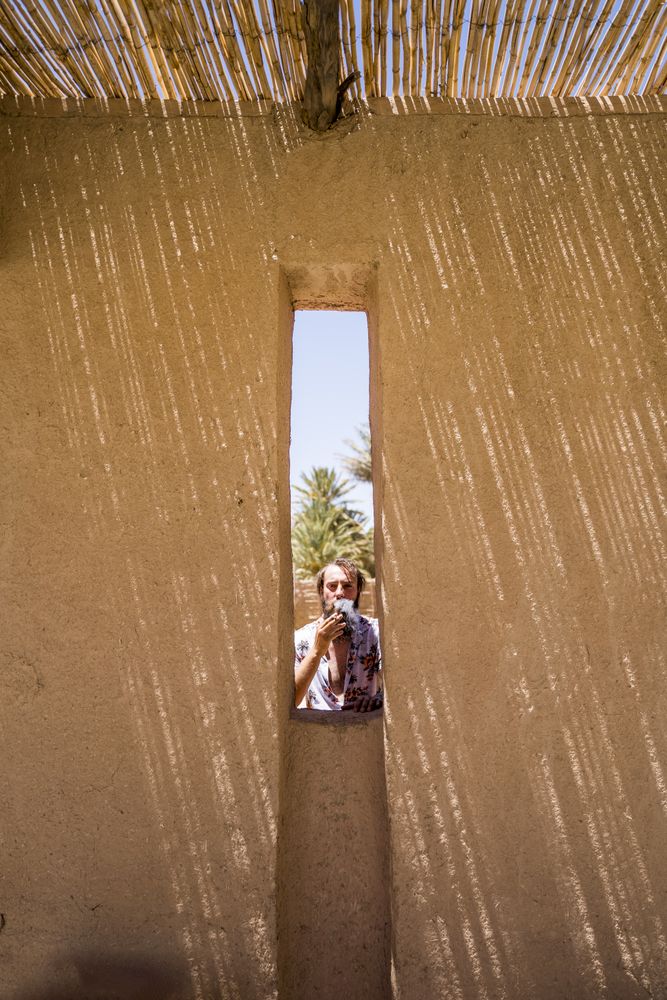 man behind stone wall