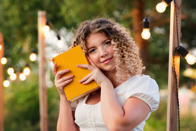 Woman with book outdoors