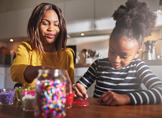 Black mother and daughter doing arts and crafts at home