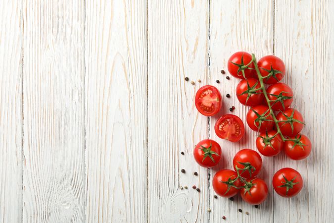 Tomatoes and pepper on wooden background, top view