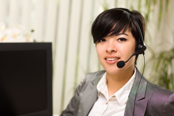 Young Woman Smiles Wearing Headset