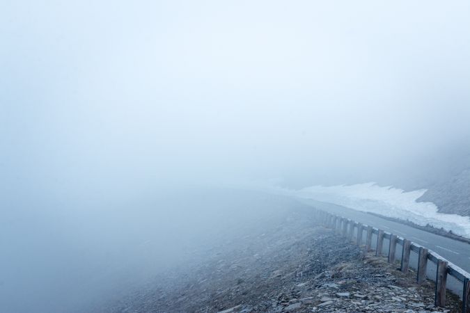 Fog over asphalt mountain road
