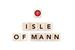 Wooden blocks bearing the name and flag of Isle Of Mann. Manx and British Culture, national identity, travel, and geography in a copy space design.