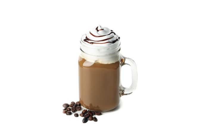 Iced coffee with poured cream isolated on plain background