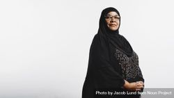 Muslim woman in hijab standing against neutral background 0L3Xgb