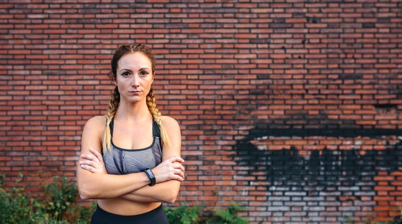 Sportswoman with crossed arms posing