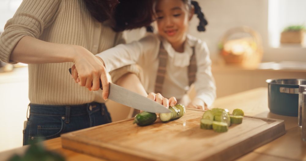 Portrait of Korean Woman and Daughter in the Kitchen Cooking Together.