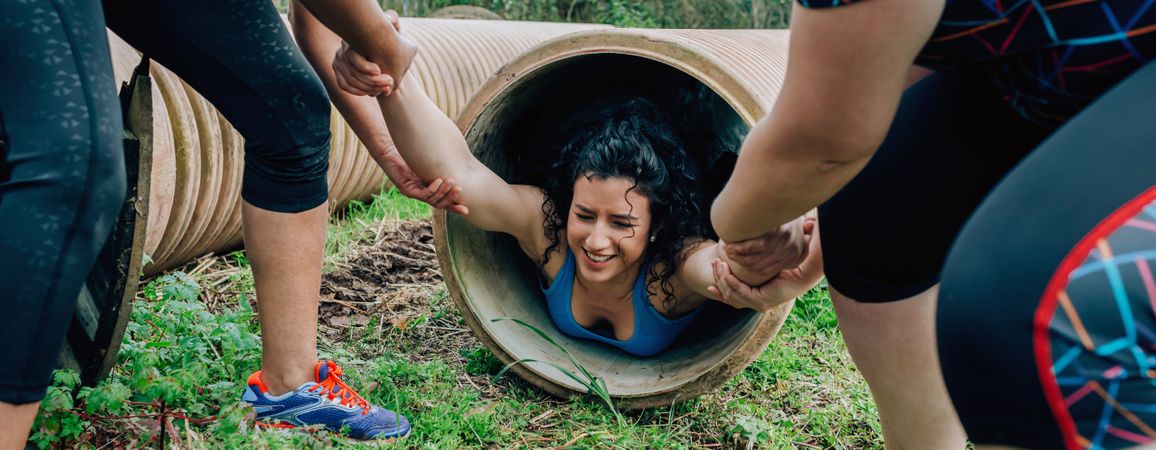 Participants obstacle course going through a pipe