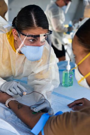 APRA, Guam - April 22, 2020: Hospitalman Apprentice takes blood sample
