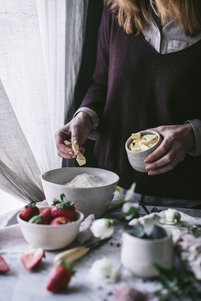 Crop woman preparing strawberry pastry