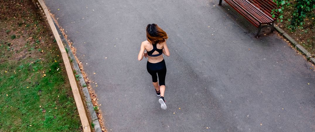 Aerial view of female runner backwards