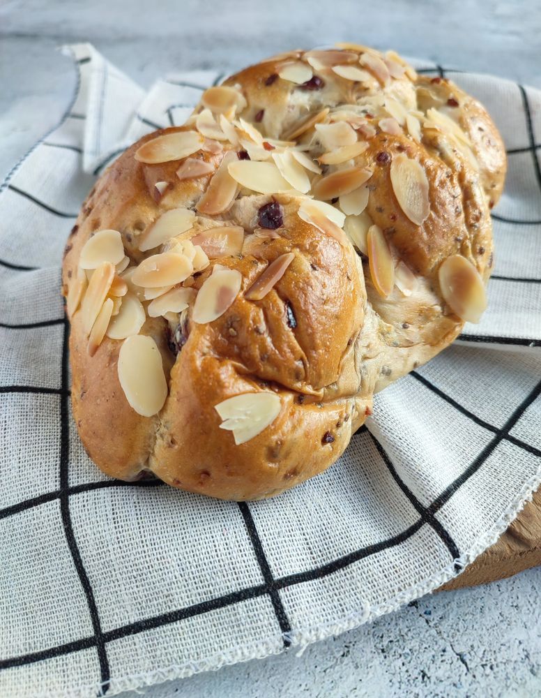 Freshly baked cranberry and cheese bread with almond slices on top
