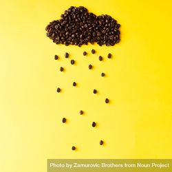 Coffee beans in shape of rainy cloud on yellow background 47nnr5