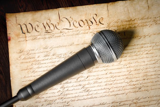 Microphone Resting on the U.S. Constitution.