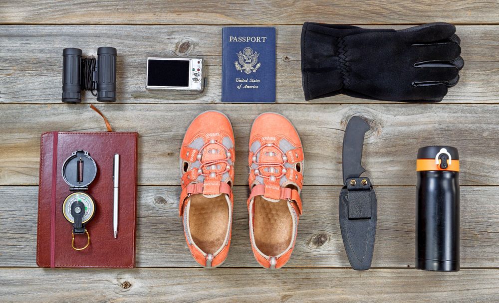 Hiking equipment neatly laid out on wooden table