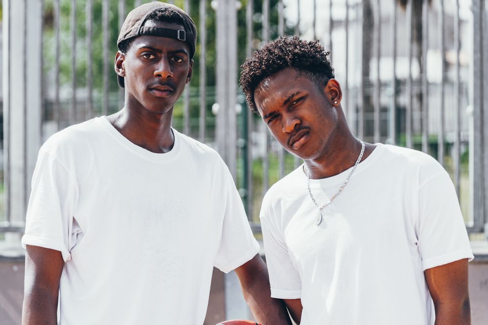 Black sportsmen with ball looking at camera