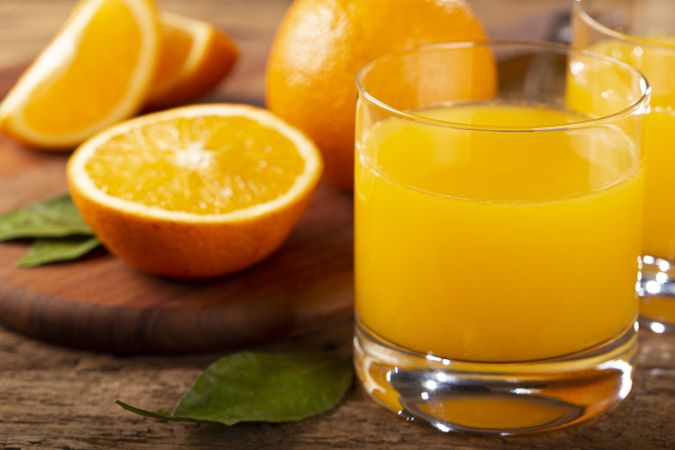 Glass with orange juice on the table.